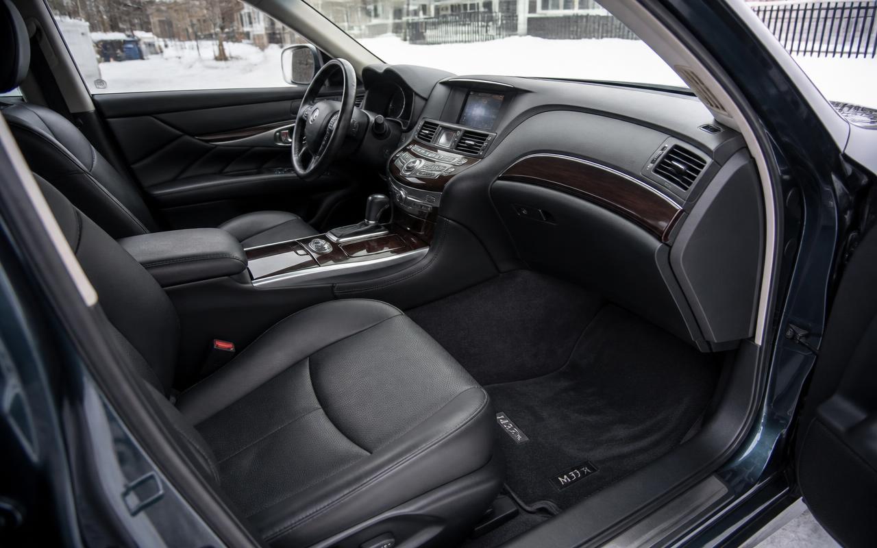 Finished vehicle interior with clean dry floor mats and polished dashboard, snow visible outside